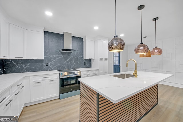 kitchen featuring a sink, light wood-type flooring, stainless steel electric stove, and wall chimney exhaust hood