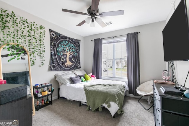 bedroom featuring ceiling fan, baseboards, visible vents, and light carpet
