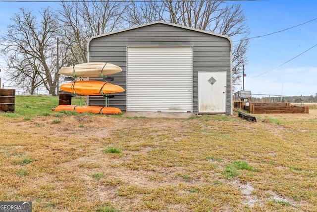 view of outdoor structure with an outbuilding and fence