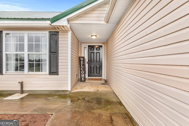 view of exterior entry with metal roof