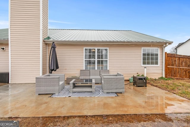 view of patio / terrace featuring an outdoor living space and fence