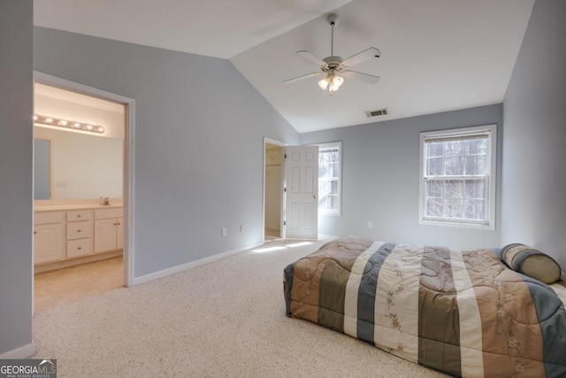 bedroom with visible vents, light carpet, connected bathroom, baseboards, and vaulted ceiling