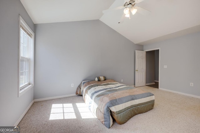 carpeted bedroom with vaulted ceiling, a ceiling fan, and baseboards