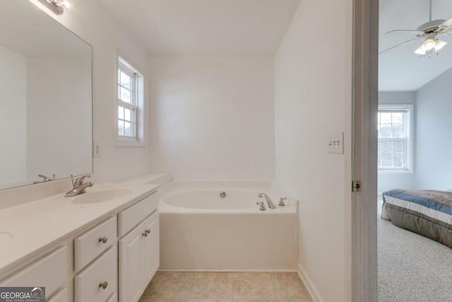 full bathroom featuring tile patterned flooring, baseboards, a bath, vanity, and a ceiling fan