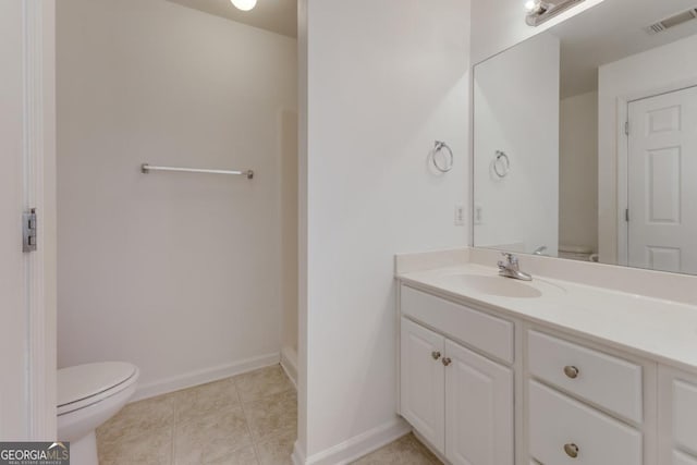 bathroom with visible vents, baseboards, toilet, tile patterned floors, and vanity