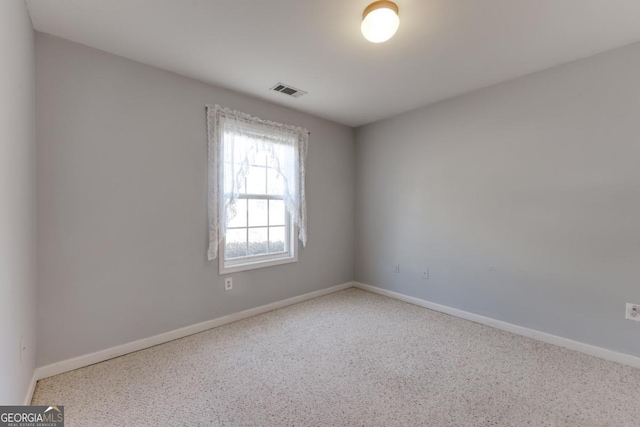 spare room with visible vents and baseboards