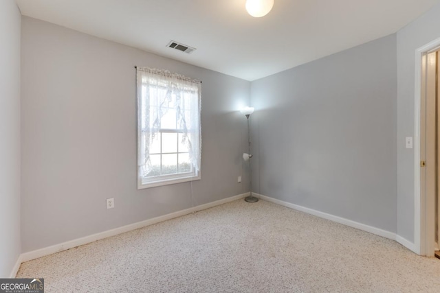 empty room with visible vents and baseboards