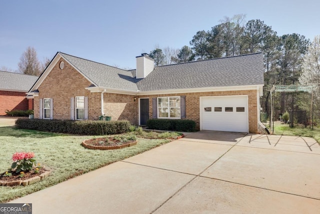 view of front of home featuring driveway, a front yard, a garage, brick siding, and a chimney