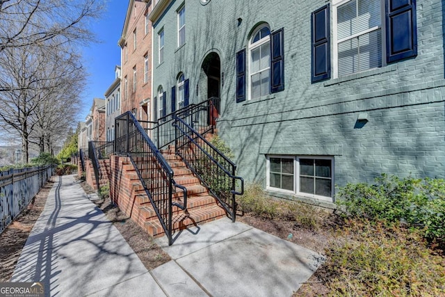 exterior space featuring stairway and fence