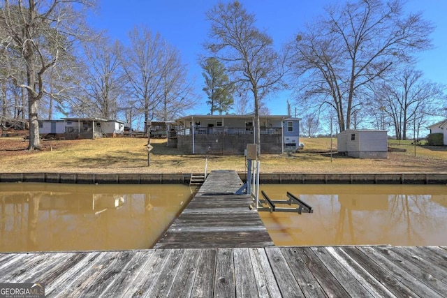 view of dock featuring boat lift and a water view