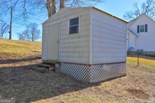 view of shed featuring fence