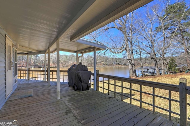 wooden terrace with a water view and grilling area