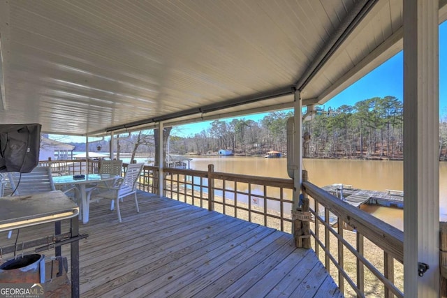 wooden deck featuring a boat dock and a water view