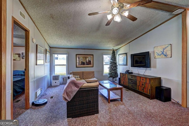 living room featuring visible vents, lofted ceiling, ornamental molding, a textured ceiling, and carpet flooring