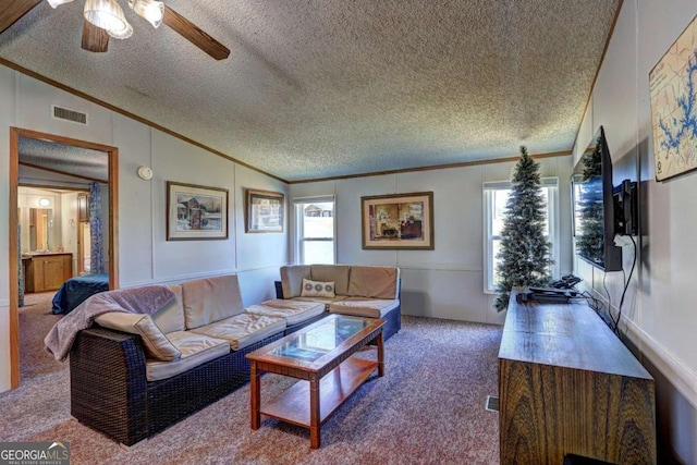 living area with visible vents, lofted ceiling, carpet floors, and crown molding