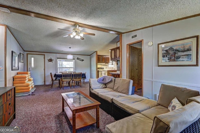 living area featuring visible vents, carpet floors, a textured ceiling, and crown molding