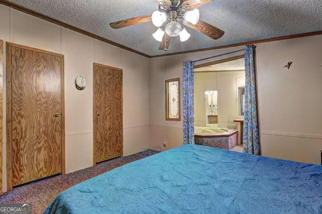 carpeted bedroom with ensuite bath, crown molding, ceiling fan, and a textured ceiling