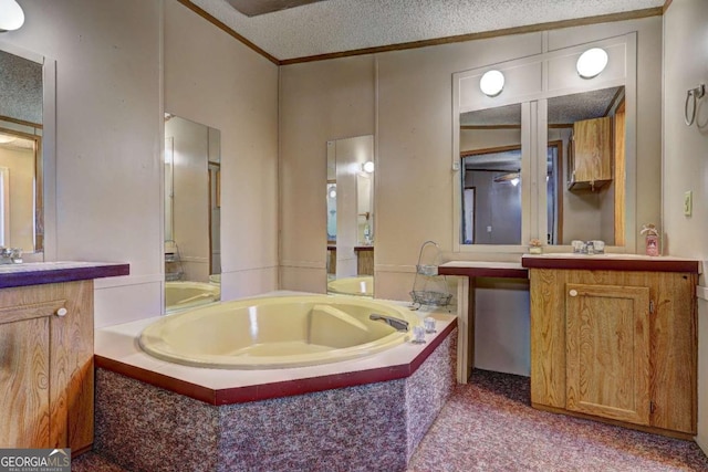 bathroom featuring a bath, ornamental molding, a textured ceiling, and two vanities