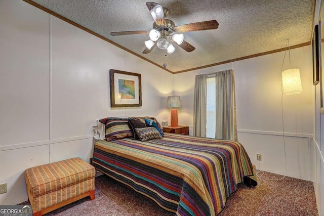 bedroom featuring a textured ceiling, a decorative wall, carpet floors, and ornamental molding