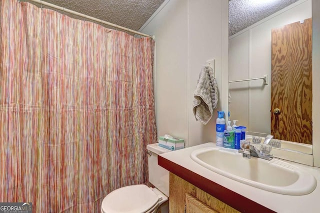 full bath with vanity, curtained shower, toilet, and a textured ceiling