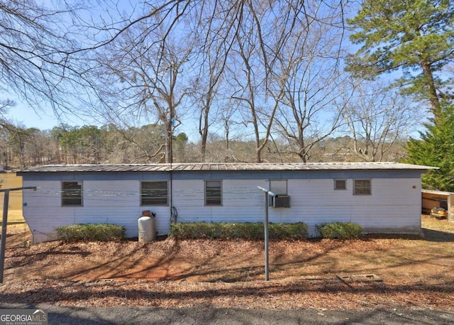 view of side of home with metal roof