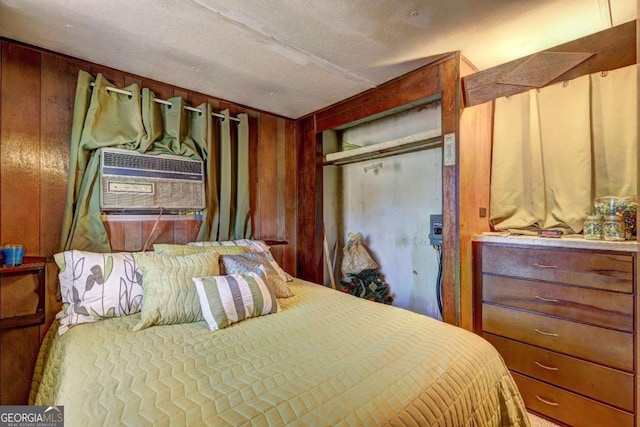 bedroom with a closet and wood walls