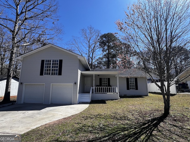 split level home with concrete driveway, a front yard, covered porch, a garage, and crawl space