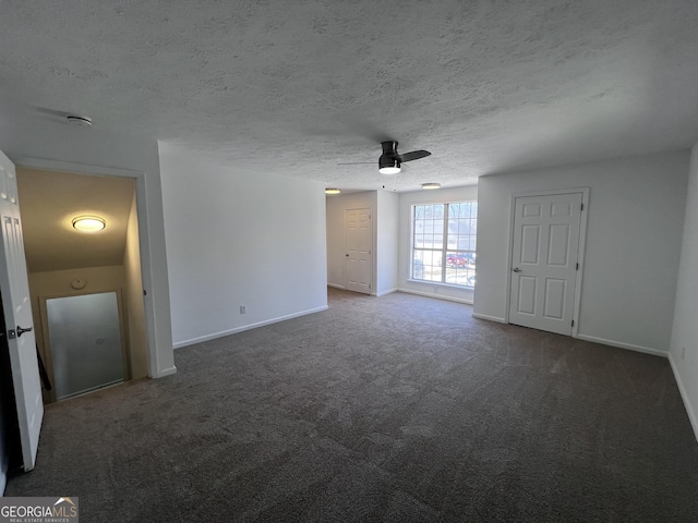 unfurnished room featuring a ceiling fan, carpet, baseboards, and a textured ceiling