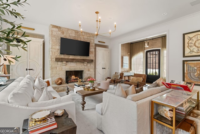 living room featuring a chandelier, a fireplace, and ornamental molding