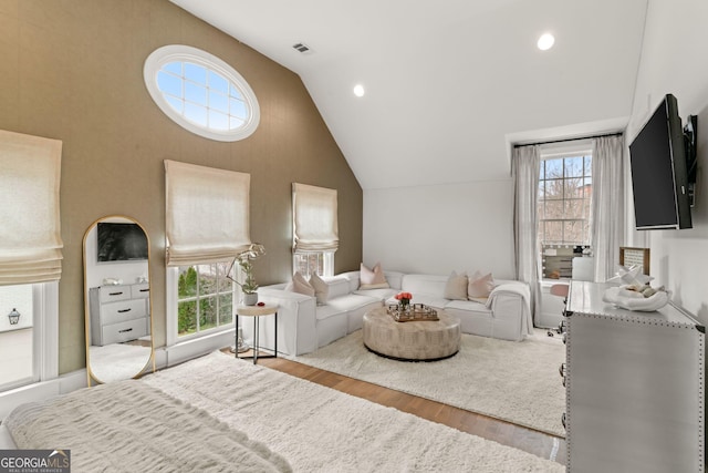 bedroom featuring vaulted ceiling, recessed lighting, visible vents, and wood finished floors