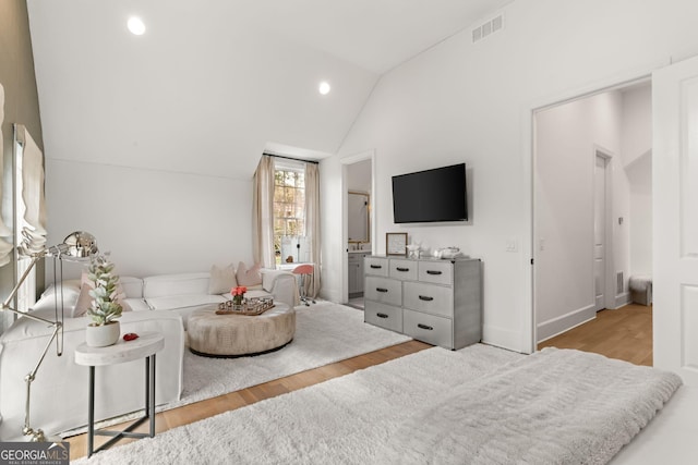 living area featuring visible vents, recessed lighting, wood finished floors, and vaulted ceiling