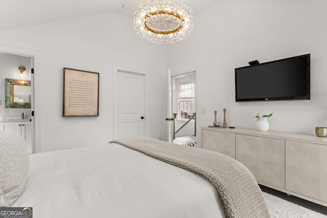 bedroom featuring a notable chandelier, a sink, and vaulted ceiling