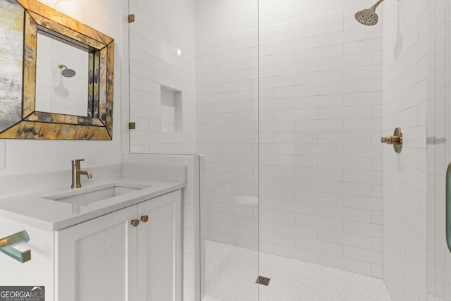 bathroom with vanity and a tile shower