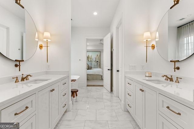 ensuite bathroom with visible vents, marble finish floor, ensuite bathroom, and a sink