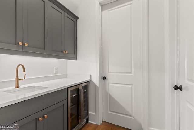 laundry room featuring a sink and wine cooler