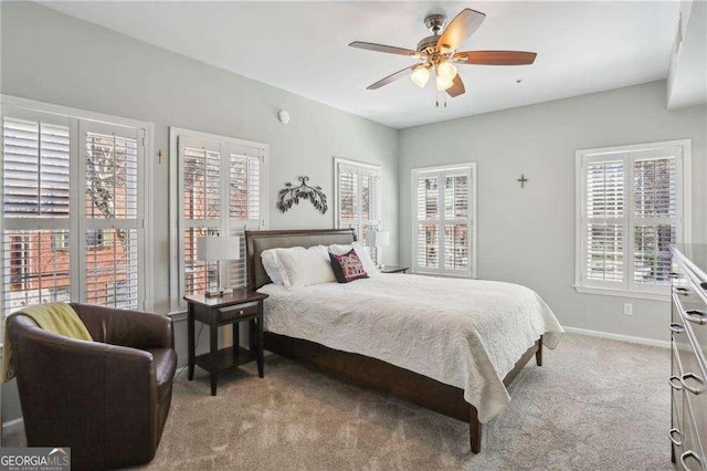 carpeted bedroom featuring baseboards and ceiling fan