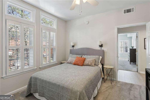 bedroom featuring visible vents, ceiling fan, carpet flooring, and baseboards