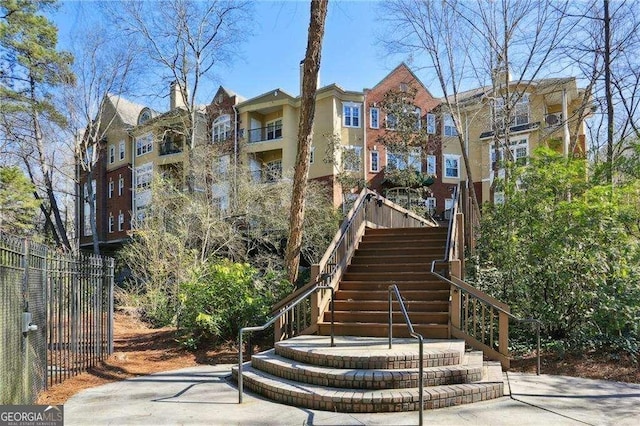 exterior space featuring stairway and fence