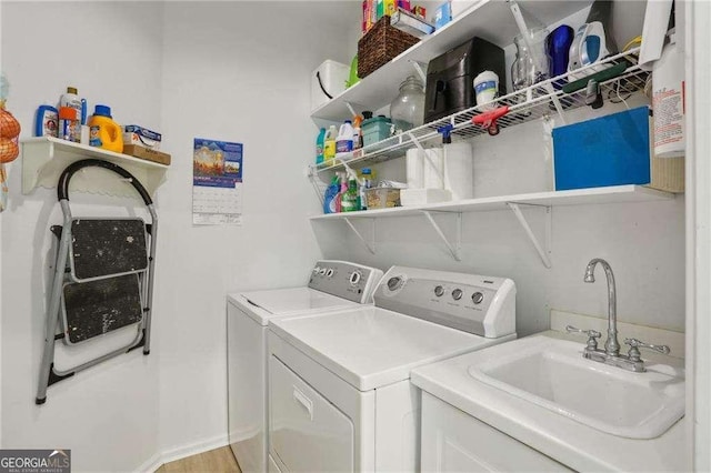 laundry area featuring laundry area, washer and dryer, and a sink