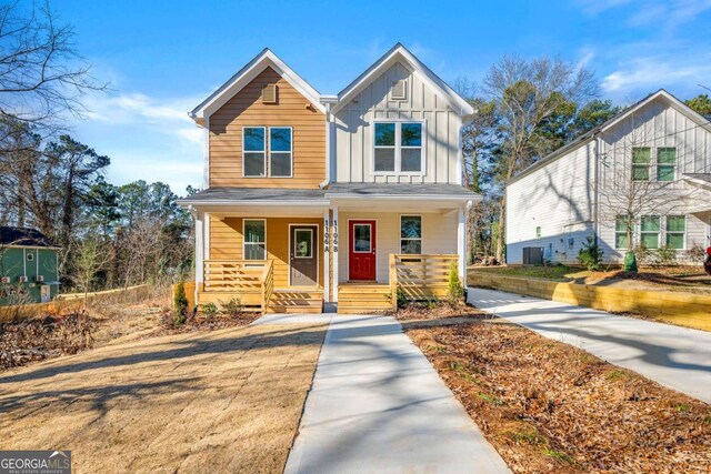view of front of house featuring a porch, central air condition unit, and board and batten siding