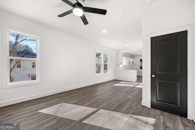 unfurnished living room with recessed lighting, baseboards, a ceiling fan, and dark wood-style flooring