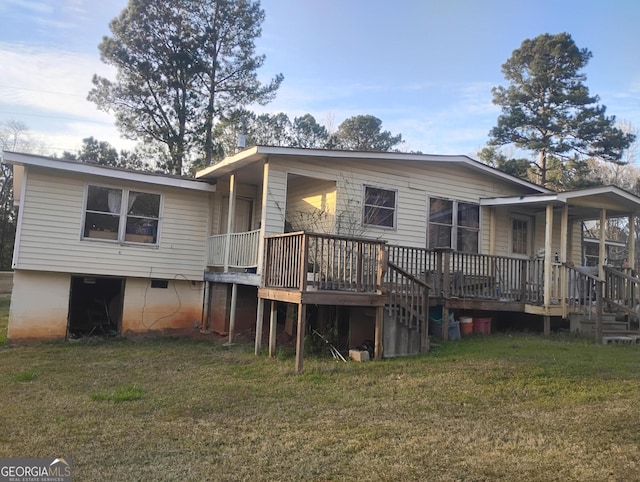 view of front facade with a wooden deck and a front yard