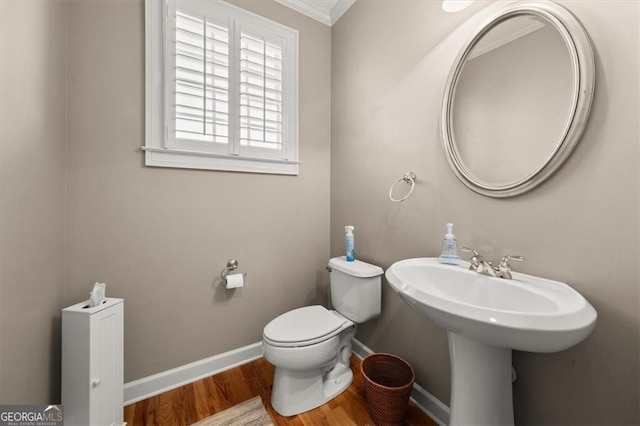 bathroom featuring baseboards, toilet, and wood finished floors