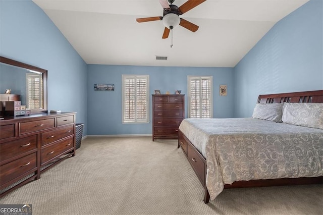 bedroom featuring visible vents, baseboards, light colored carpet, lofted ceiling, and a ceiling fan