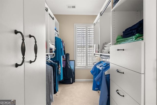 walk in closet with visible vents and carpet flooring