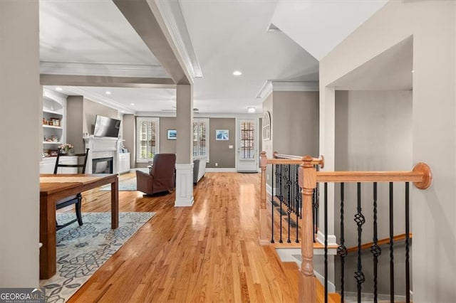 hallway featuring an upstairs landing, ornamental molding, wood finished floors, recessed lighting, and baseboards