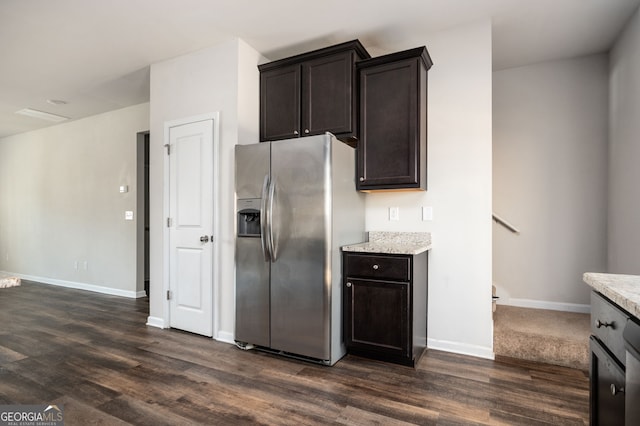 kitchen with baseboards, dark brown cabinets, dark wood-style flooring, and stainless steel refrigerator with ice dispenser