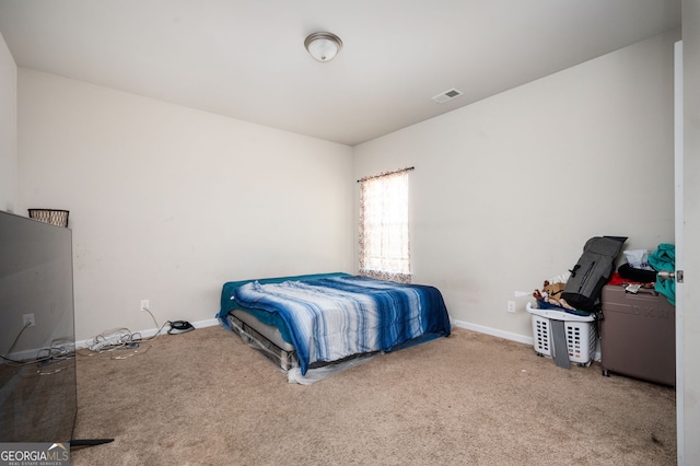 carpeted bedroom featuring visible vents and baseboards