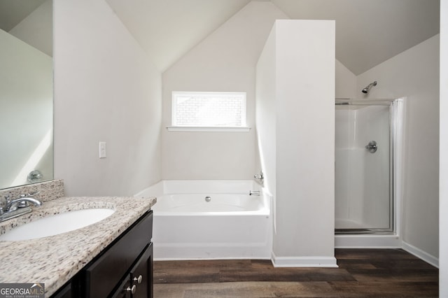 bathroom with vanity, lofted ceiling, wood finished floors, and a shower stall