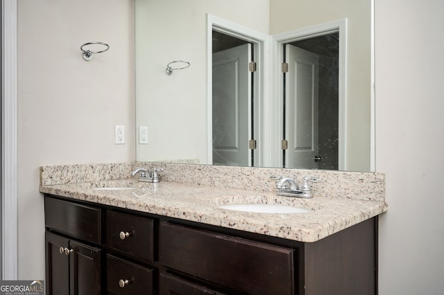 bathroom featuring double vanity and a sink